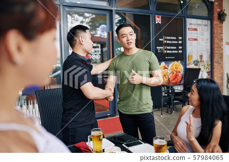 Meeting of friends in cafe 57984065