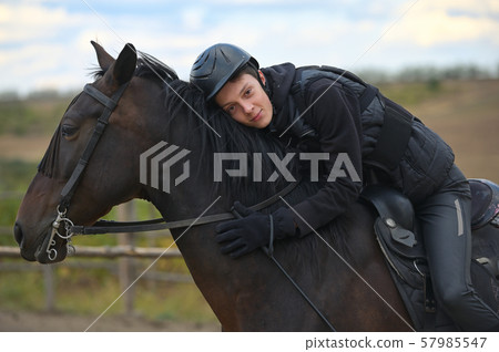 Teenage boy with a horse 57985547