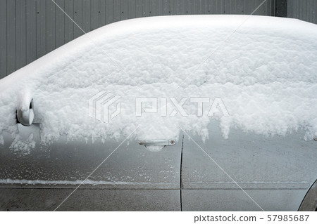 Poor visibility on the road. Car side view. Car under the snow. Automobile covered with white snow Poor visibility on the road. Car side view. Car under the snow. Automobile covered with white snow 57985687
