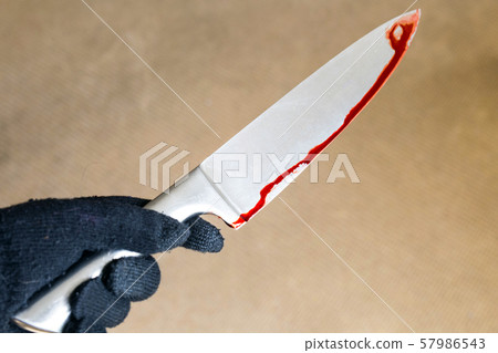 murder and crime scene concept - close up of criminal or murderer hand in glove with blood on knife 57986543