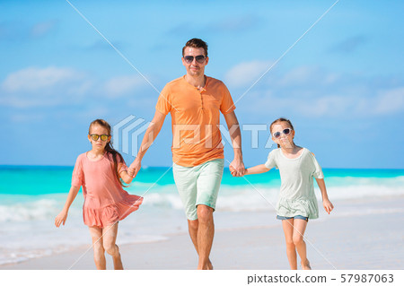 Father and kids enjoying beach summer vacation 57987063