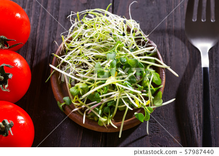 Fresh mixed onion and radish micro greens in wooden bown with cherry tomatoes 57987440