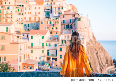 Tourist looking at scenic view of Manarola, Cinque Terre, Liguria, Italy Tourist looking at scenic view of Manarola, Cinque Terre, Liguria, Italy 57987705