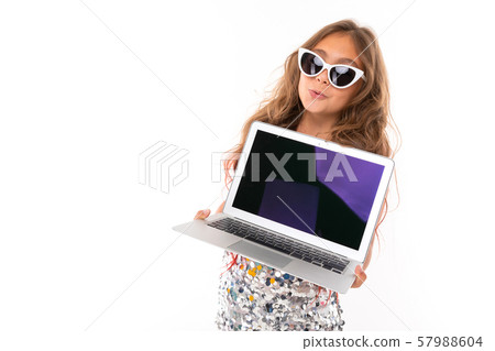 Teenage girl in sparkling dress and fashionable white sunglasses holding innovative laptop with Teenage girl in sparkling dress and fashionable white sunglasses holding innovative laptop with 57988604