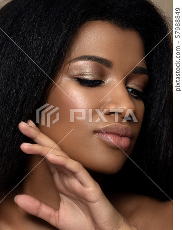 Young beautiful black woman touching her face 57988849