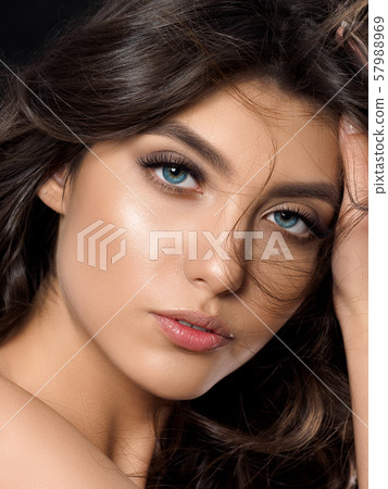 Portrait of young beautiful woman over dark background 57988969
