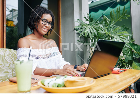 Woman typing on laptop 57989321