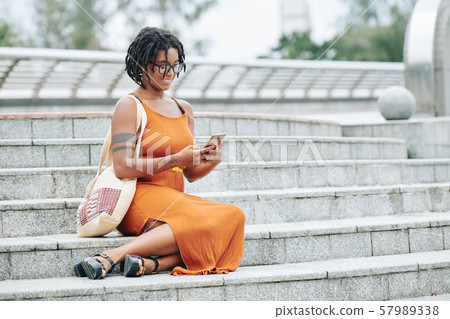 Woman resting on stairs outdoors 57989338