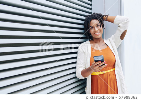African woman communicating online on the phone African woman communicating online on the phone 57989362