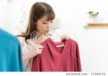 A woman choosing clothes A woman choosing clothes 57989510