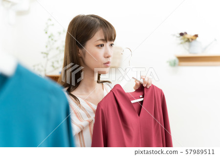 A woman choosing clothes A woman choosing clothes 57989511