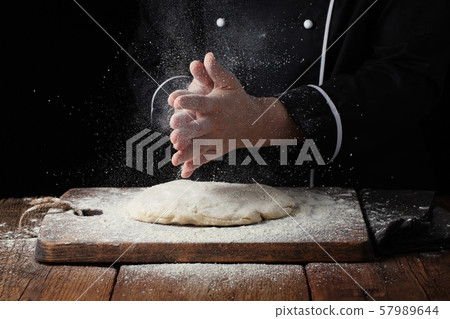 Woman chef hand clap with splash of white flour. Woman chef hand clap with splash of white flour. 57989644