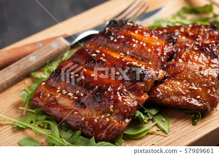 Closeup of pork ribs grilled with BBQ sauce. 57989661