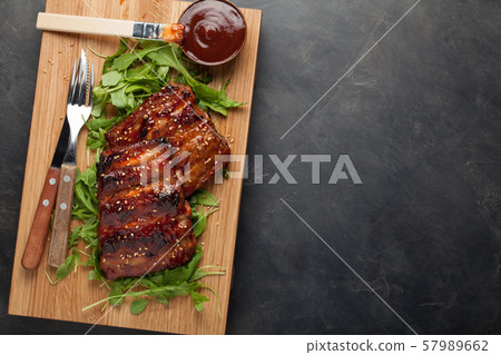 Closeup of pork ribs grilled with BBQ sauce. 57989662