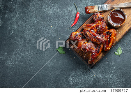 Roasted chicken wings in barbecue sauce. 57989737