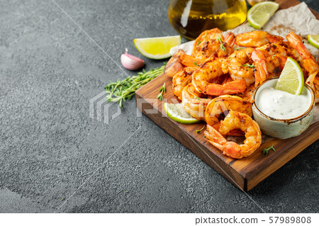 Grilled shrimps or prawns served with lime. 57989808