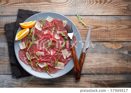 Marbled beef carpaccio with arugula. Marbled beef carpaccio with arugula. 57989817