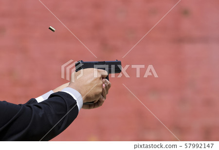 Closeup view of hand holding a pistol / handgun 57992147