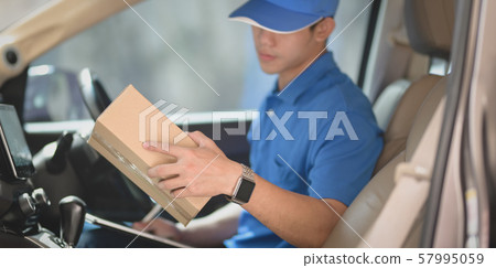 Young startup man checking orders for customers 57995059