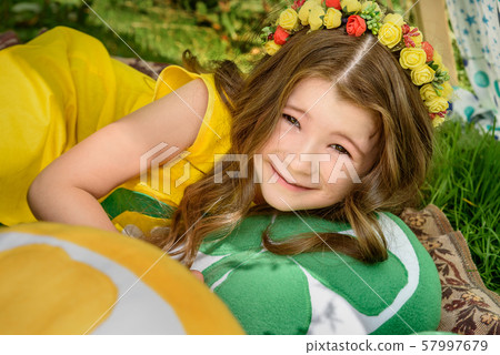 Young girl lying on pillows oranges in tent in Young girl lying on pillows oranges in tent in 57997679