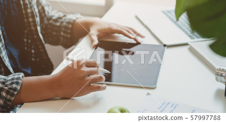 Young photographer planing his idea on tablet in 57997788