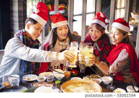 Happy friends having fun and celebrating christmas Happy friends having fun and celebrating christmas 58001594