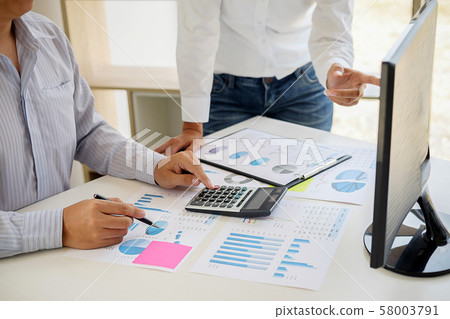 Business adviser analyzing financial figures 58003791