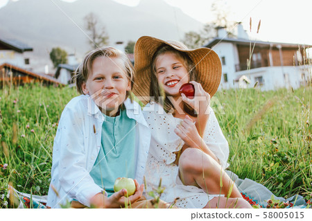 Funny children with apples brother and sister 58005015