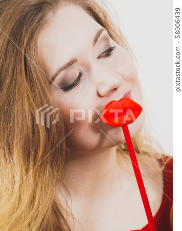 Woman holding big red fake lips 58006439