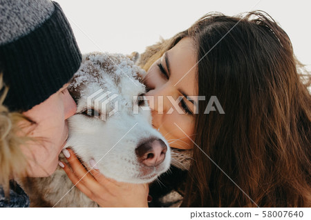 The happy couple kissing dog haski at forest The happy couple kissing dog haski at forest 58007640