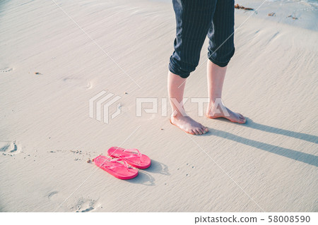 Bare feet and sandals on the sandy beach (the most beautiful Yonaha Maehama Beach in the Orient) 58008590