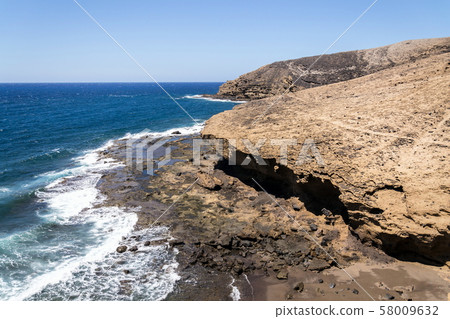 Waves breaking on dramatic cliffs on southern coast, Montana Pelada mountain, Tenerife, Waves breaking on dramatic cliffs on southern coast, Montana Pelada mountain, Tenerife, 58009632