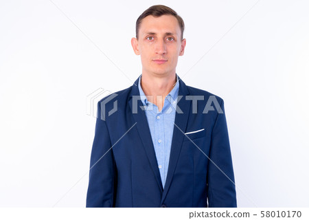 Studio shot of businessman in suit looking at camera Studio shot of businessman in suit looking at camera 58010170