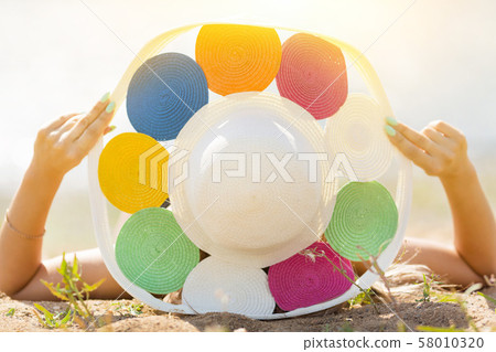 The girl in the hat lies on her back The girl in the hat lies on her back 58010320