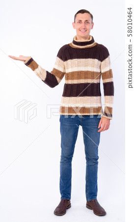 Full body shot of happy man showing something ready for winter 58010464