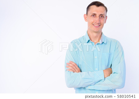 Studio shot of happy businessman smiling with arms crossed 58010541