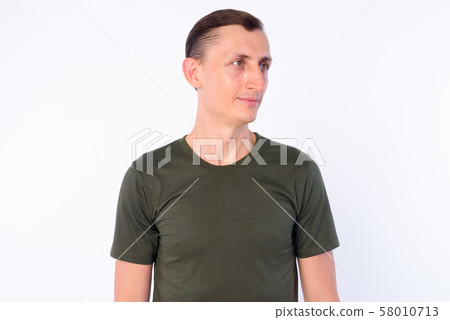Studio shot of man thinking and looking away 58010713
