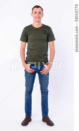 Full body shot of happy man smiling and looking at camera 58010779