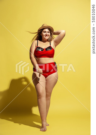 Young caucasian plus size female model's preparing for beach resort Young caucasian plus size female model's preparing for beach resort 58010846