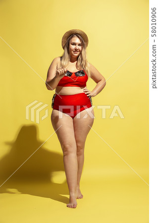 Young caucasian plus size female model's preparing for beach resort Young caucasian plus size female model's preparing for beach resort 58010906