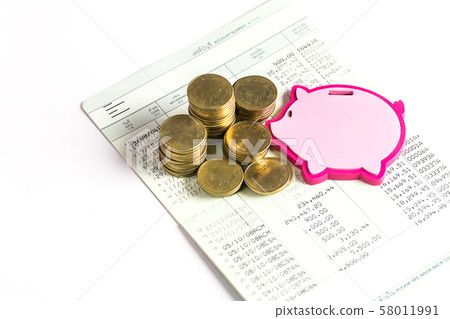 Gold coins with piggy bank shaped and book bank on 58011991
