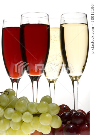 champagne glasses with grapes on grey closeup 58012196