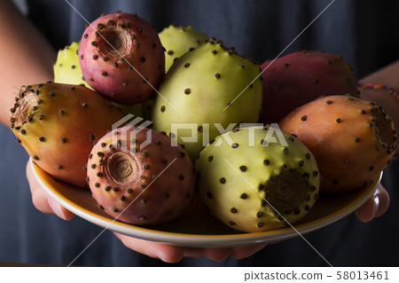 Female hands hold a plate with ripe fresh fruits Female hands hold a plate with ripe fresh fruits 58013461