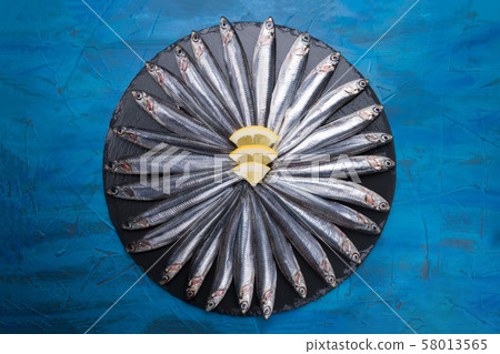 Fish pattern. Anchovies in the shape of a circle Fish pattern. Anchovies in the shape of a circle 58013565
