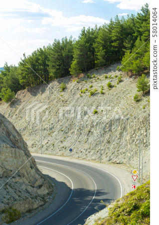 Sharp turn of mountain highway in the Caucasus mountains near Gelendzhik resort city. Sharp turn of mountain highway in the Caucasus mountains near Gelendzhik resort city. 58014064