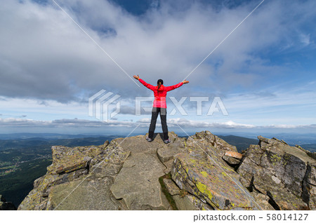 girl athlete on top of the mountain. 58014127