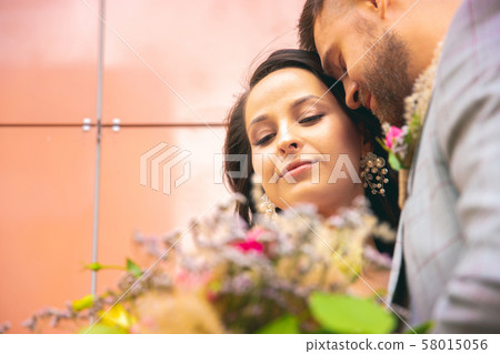Caucasian romantic young couple celebrating their marriage in city 58015056