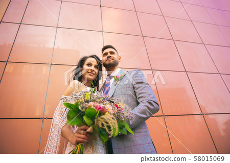 Caucasian romantic young couple celebrating their marriage in city 58015069