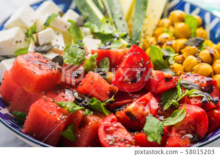 Chickpea watermelon salad with feta and tomatoes 58015203