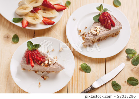 Raw vegan cheesecake with strawberry and banana 58015290